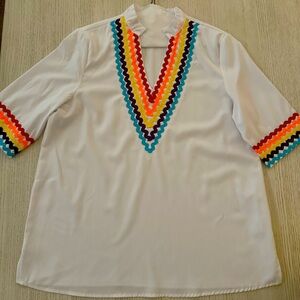 Mazic brand white top with colorful accents